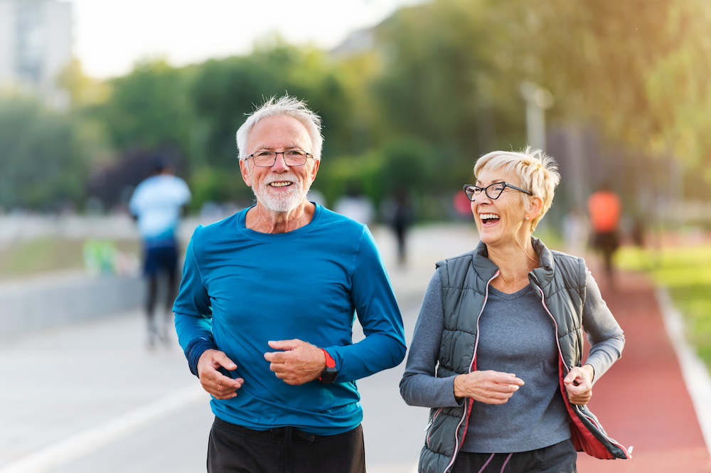 A happy senior couple out on a jog