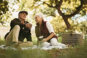 A senior couple enjoying an outdoor picnic near the Omaha assisted living community